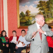 Dr. John Gump performs at the annual EKURA Christmas Party